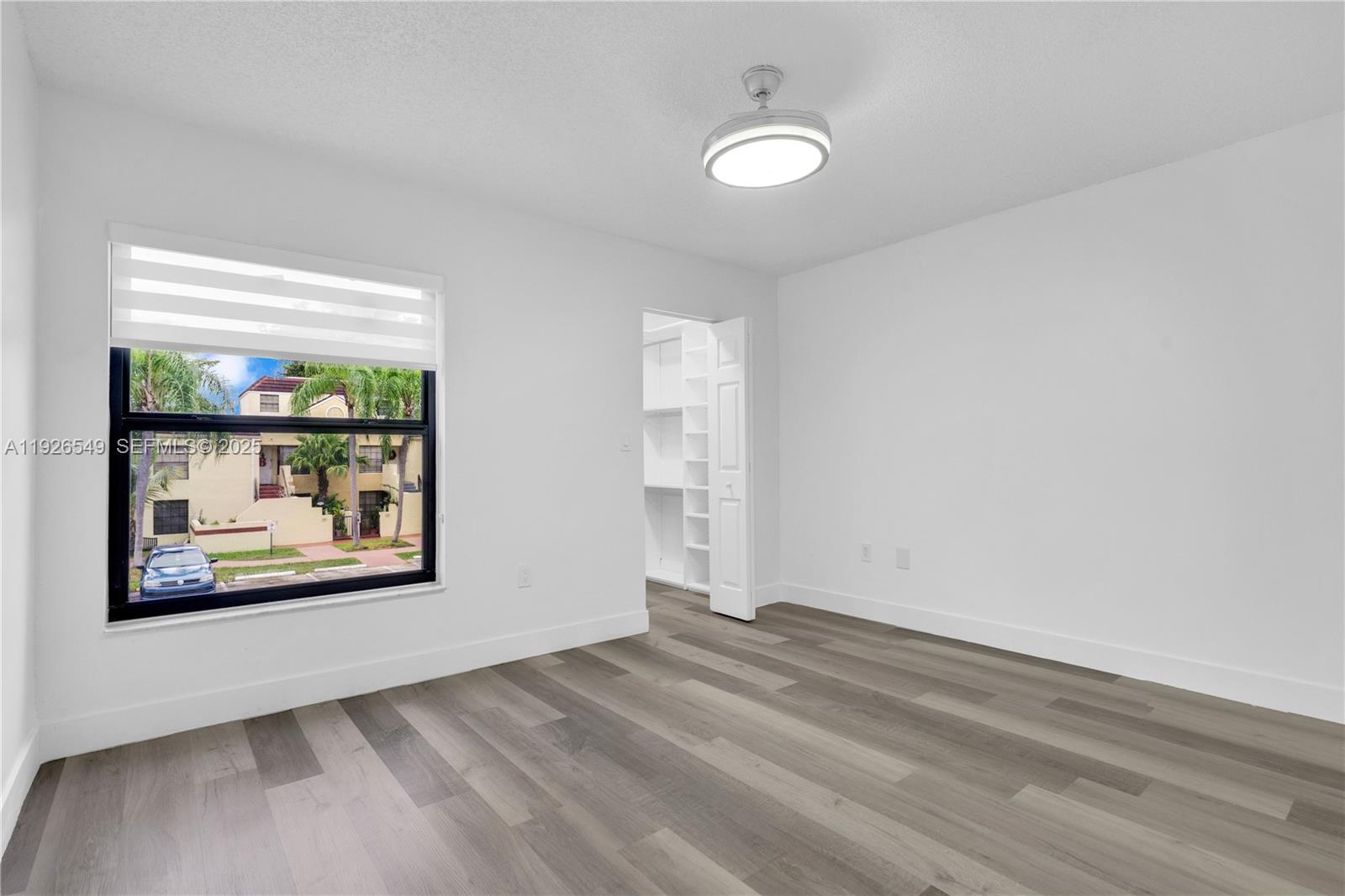 13028 Southwest 88th Lane, Unit A205 Miami, FL 33186 - Photo 27 of 37 a view of a hallway with wooden floor and a fireplace