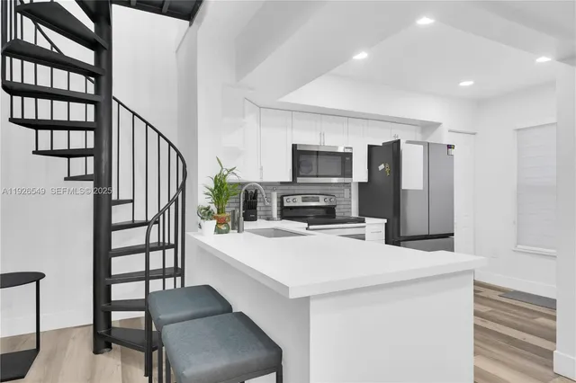 a kitchen with sink cabinets and appliances