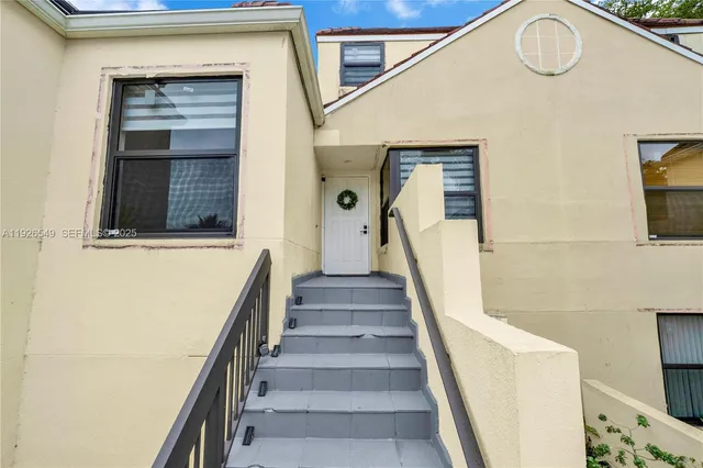 a view of staircase with white walls and a window