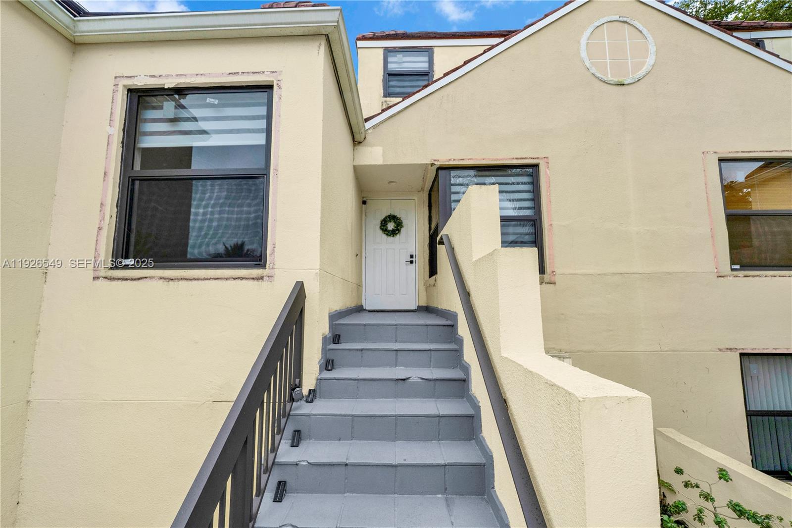 13028 Southwest 88th Lane, Unit A205 Miami, FL 33186 - Photo 3 of 37 a view of staircase with white walls and a window