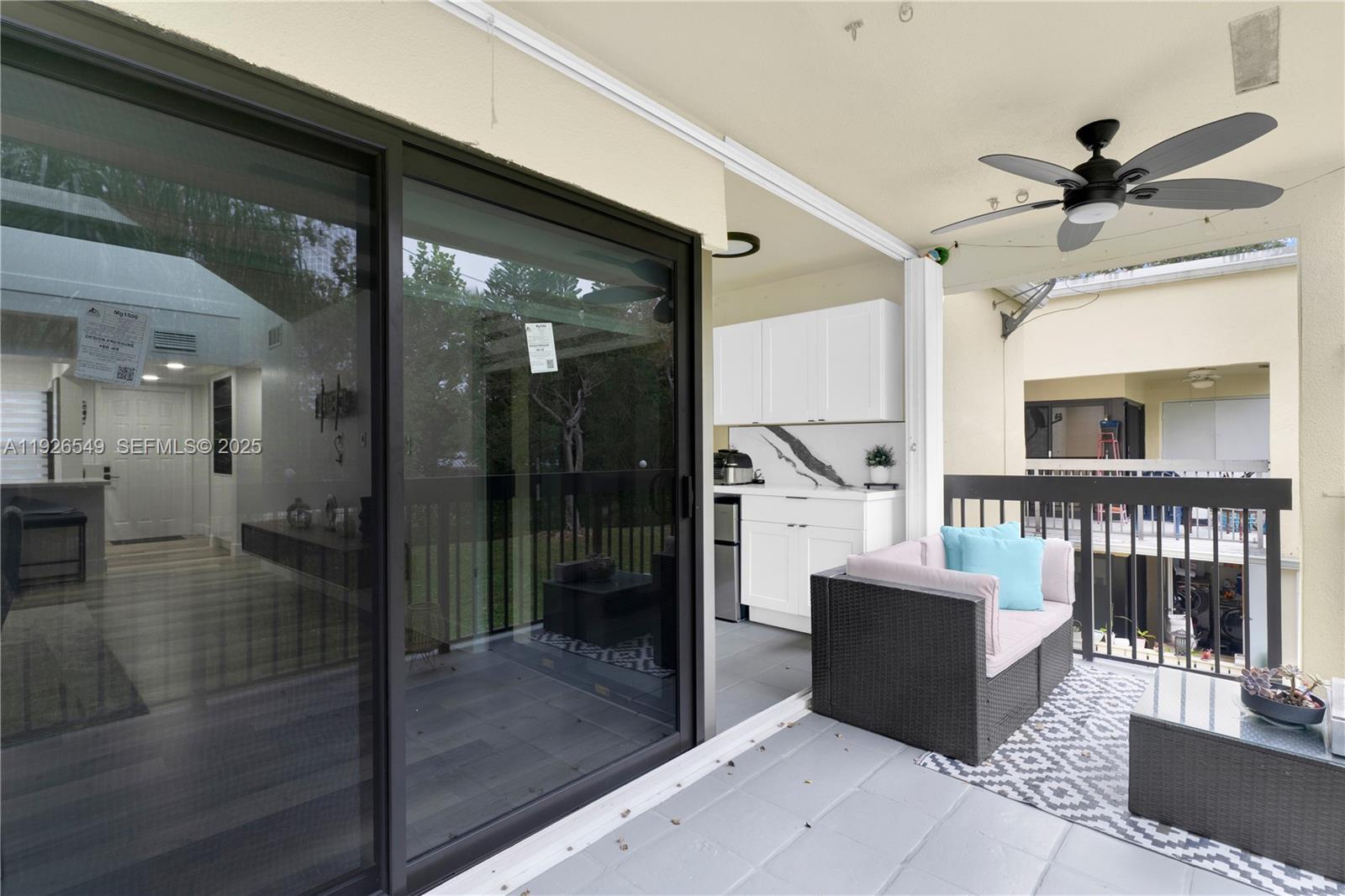 13028 Southwest 88th Lane, Unit A205 Miami, FL 33186 - Photo 32 of 37 a living room with couches a coffee table and a fireplace