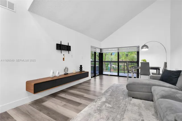 a spacious bedroom with a bed a couch and a large window