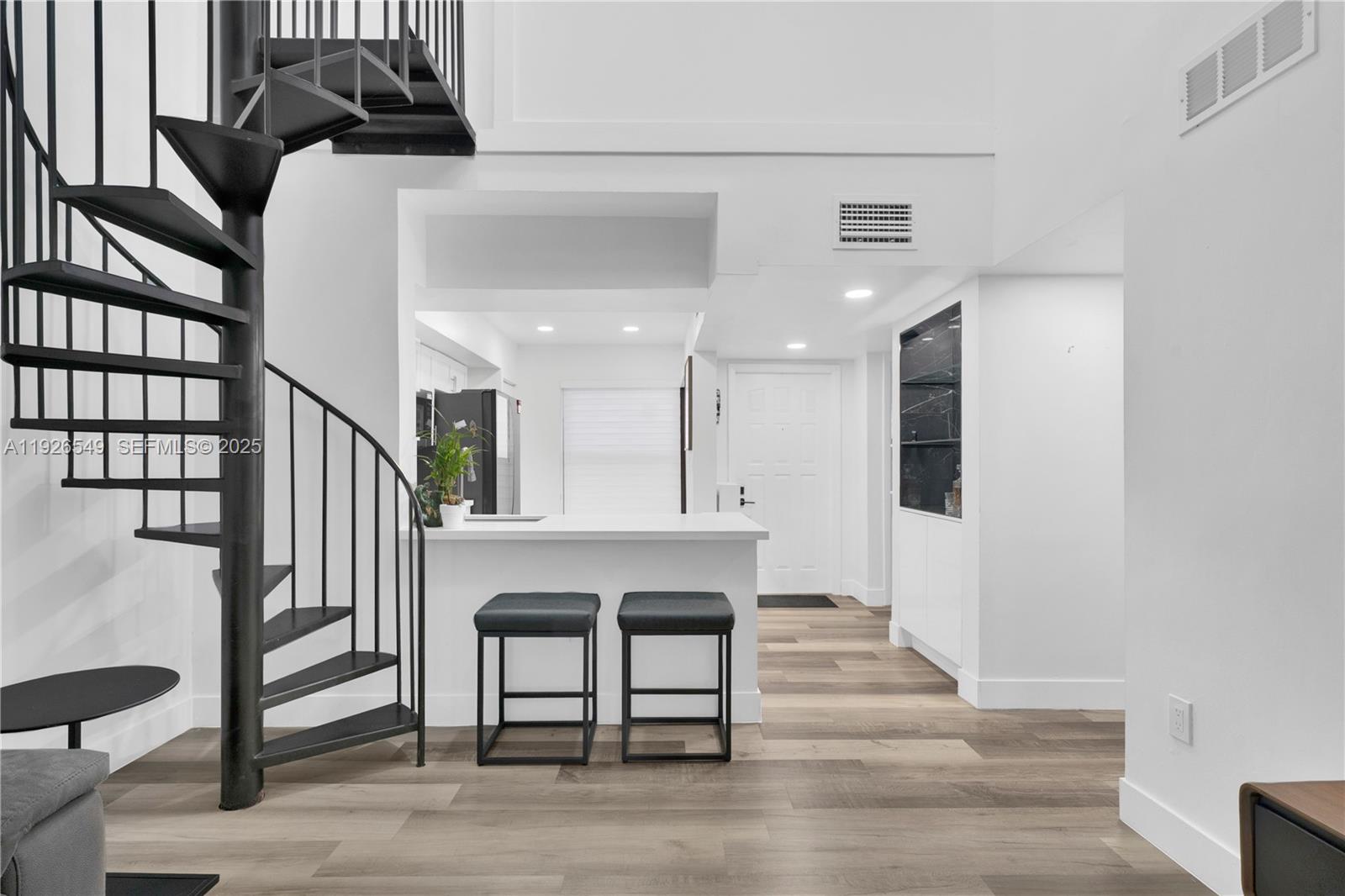 13028 Southwest 88th Lane, Unit A205 Miami, FL 33186 - Photo 9 of 37 a living room with furniture and a wooden floor