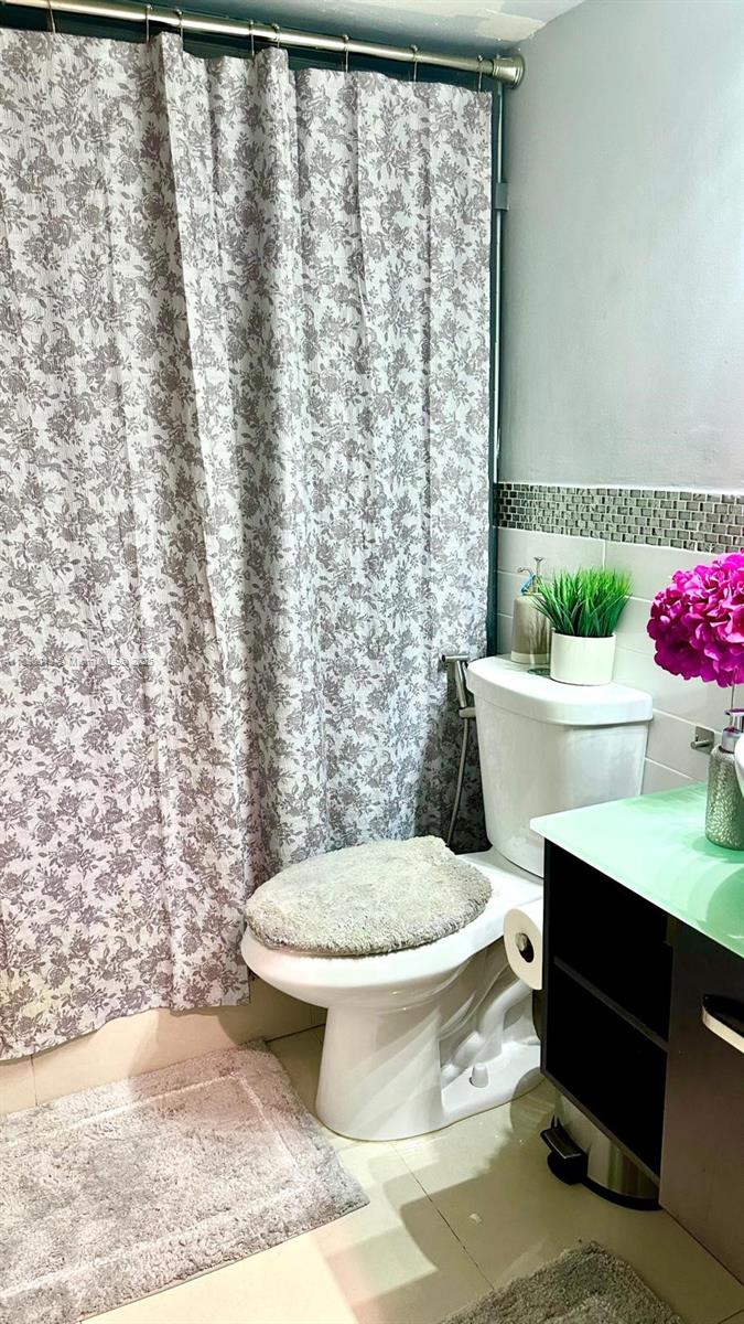 18880 Northwest 57th Avenue, Unit 208 Hialeah, FL 33015 - Photo 11 of 28 a bathroom with a toilet a sink and a shower