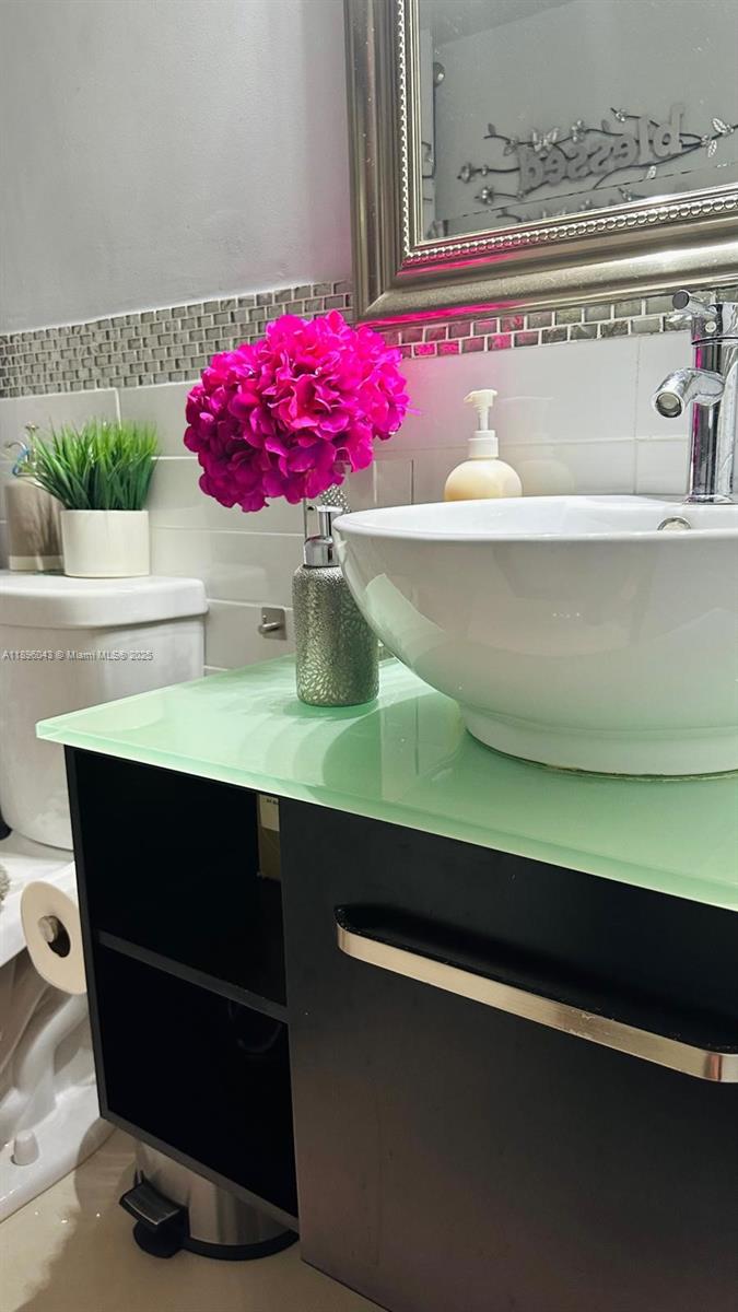 18880 Northwest 57th Avenue, Unit 208 Hialeah, FL 33015 - Photo 12 of 28 a view of cabinet with a chair and potted plant