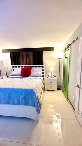 a bedroom with a large bed and a large window