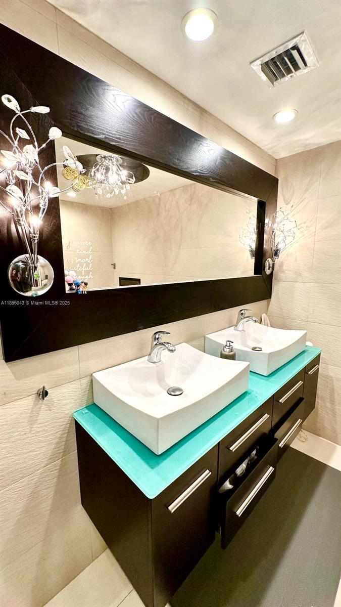 18880 Northwest 57th Avenue, Unit 208 Hialeah, FL 33015 - Photo 20 of 28 a bathroom with a sink and a mirror