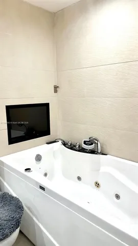 a bathroom with a tub and white tub