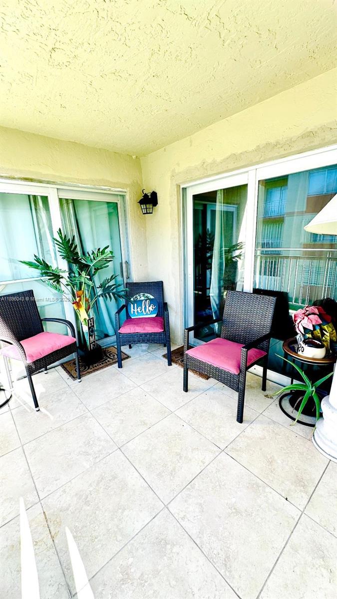 18880 Northwest 57th Avenue, Unit 208 Hialeah, FL 33015 - Photo 24 of 28 a living room with furniture and a potted plant