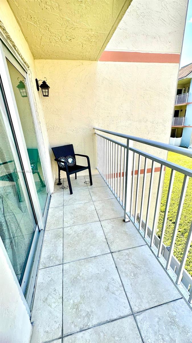 18880 Northwest 57th Avenue, Unit 208 Hialeah, FL 33015 - Photo 27 of 28 a balcony with view of outdoor space