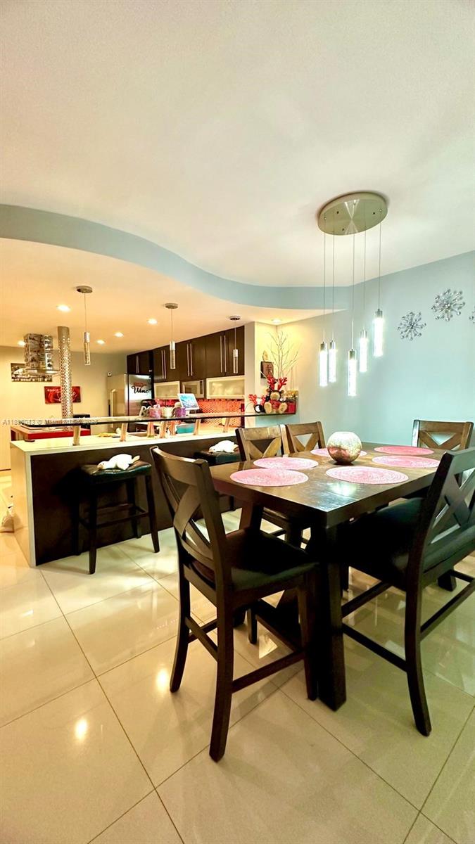 18880 Northwest 57th Avenue, Unit 208 Hialeah, FL 33015 - Photo 3 of 28 a room with a table and chairs