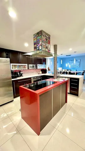 a kitchen with stainless steel appliances granite countertop a stove top oven and cabinets