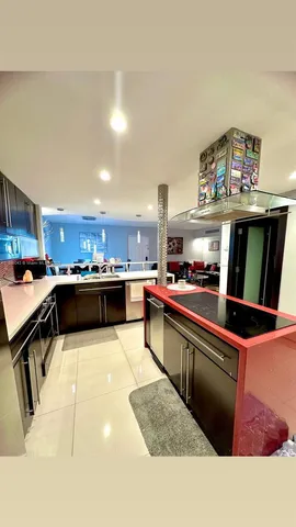 a kitchen with stainless steel appliances kitchen island granite countertop a sink and cabinets