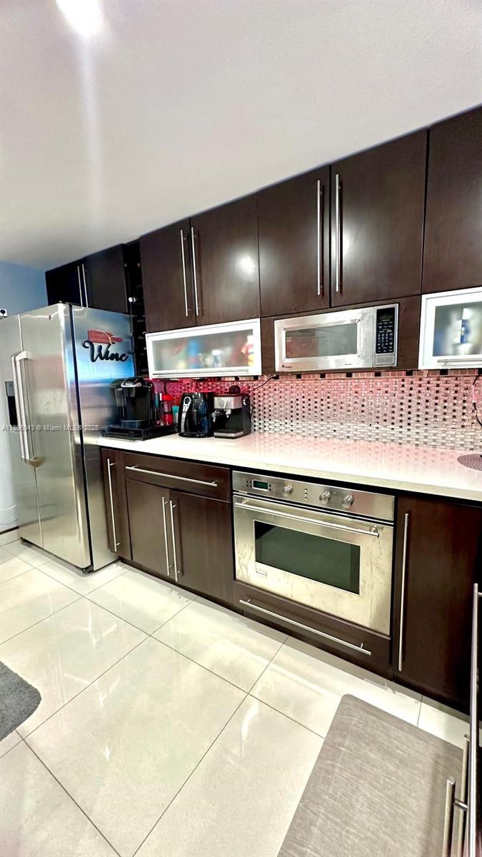 18880 Northwest 57th Avenue, Unit 208 Hialeah, FL 33015 - Photo 9 of 28 a kitchen with stainless steel appliances granite countertop a stove a sink and a refrigerator