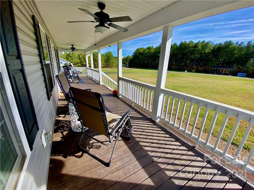 6316 Bill Sain Road Vale, NC 28168 - Photo 2 of 15 a view of balcony with wooden floor and outdoor seating