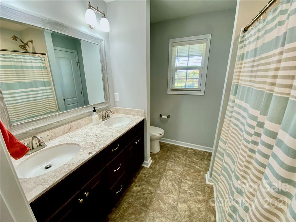 6316 Bill Sain Road Vale, NC 28168 - Photo 6 of 15 a bathroom with a sink double vanity and a mirror