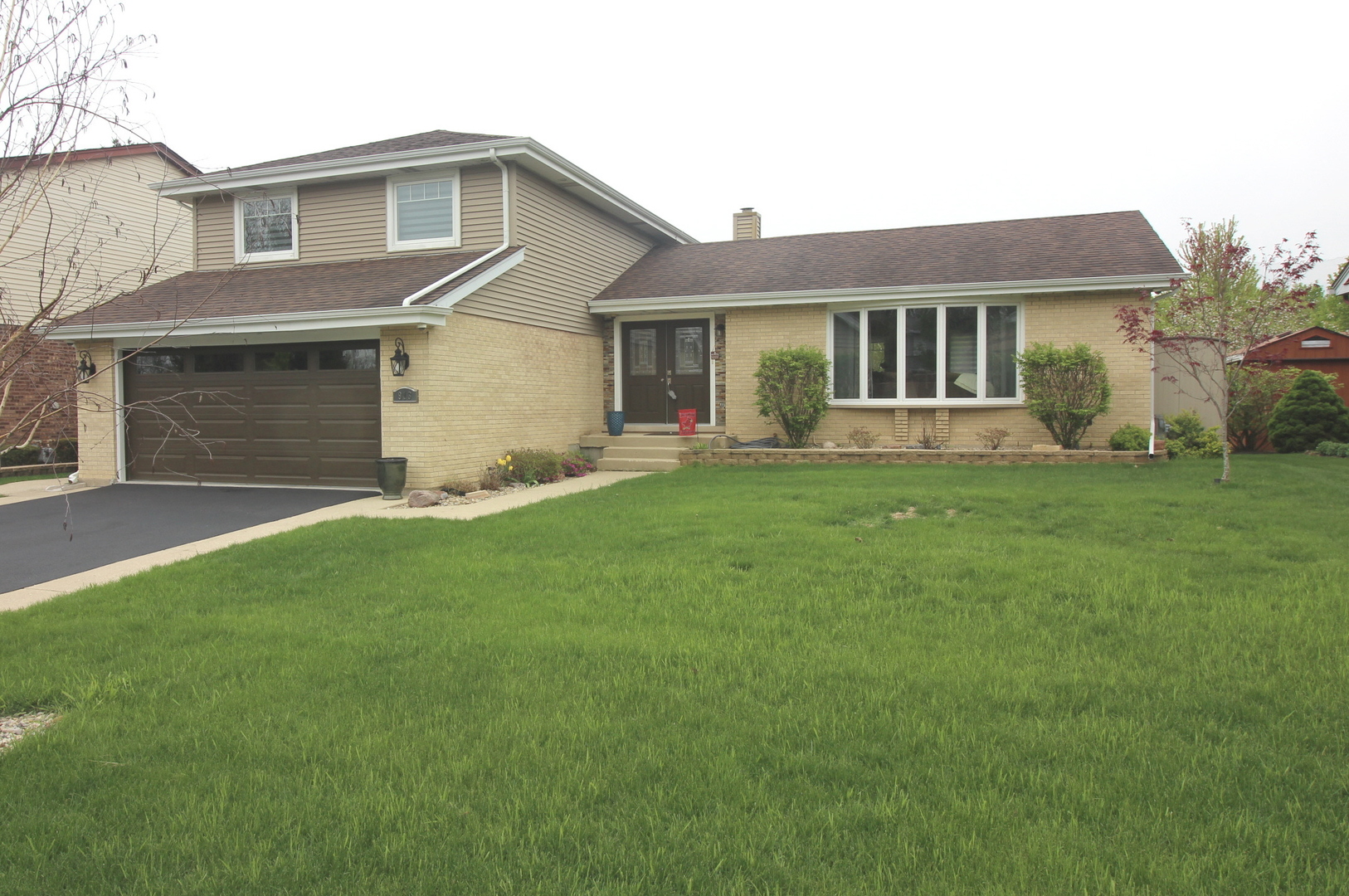 913 Surrey Road Addison, IL 60101 - Photo 1 of 44 a front view of a house with a garden and yard