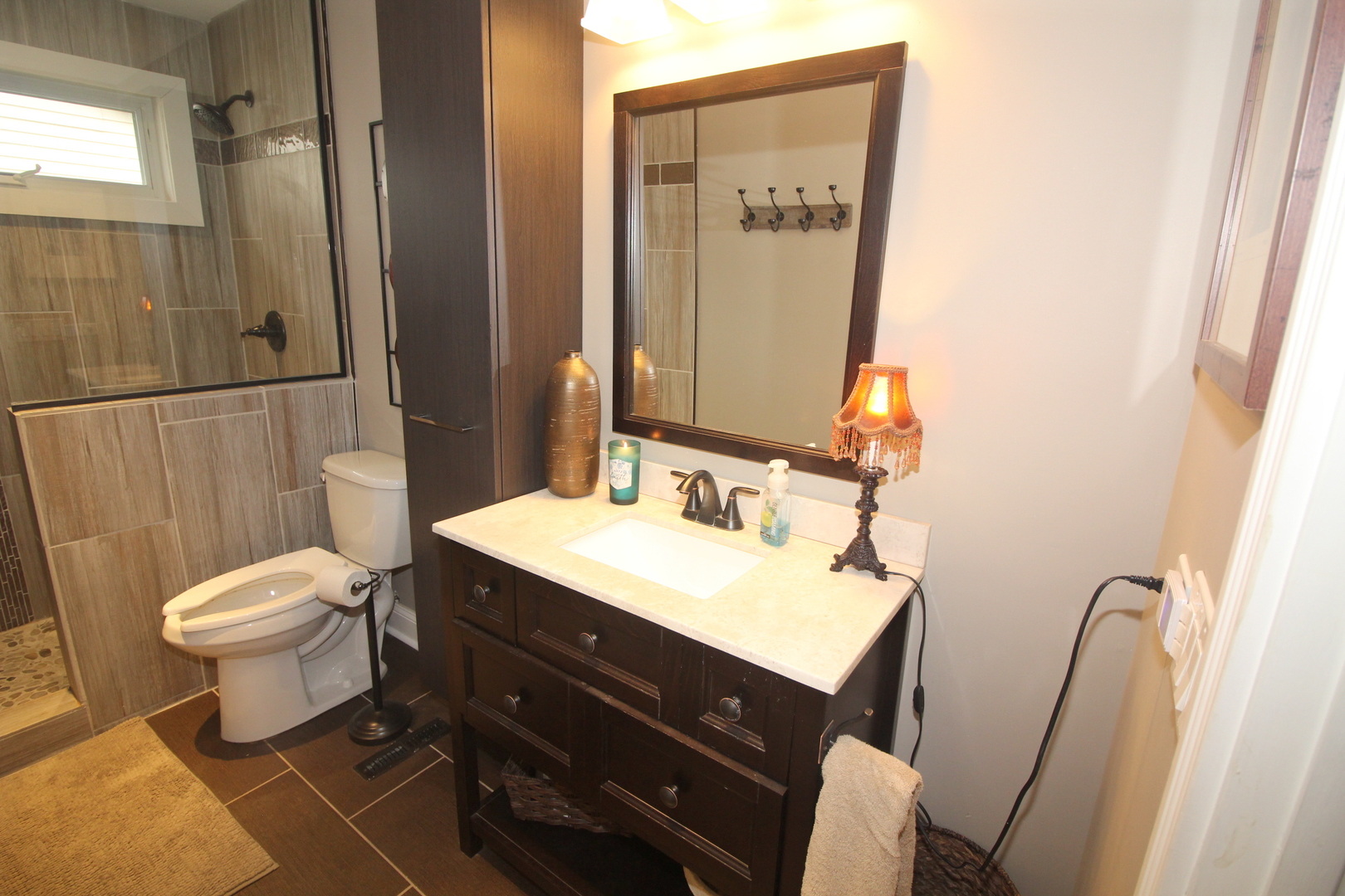 913 Surrey Road Addison, IL 60101 - Photo 27 of 44 a bathroom with a sink vanity mirror and toilet