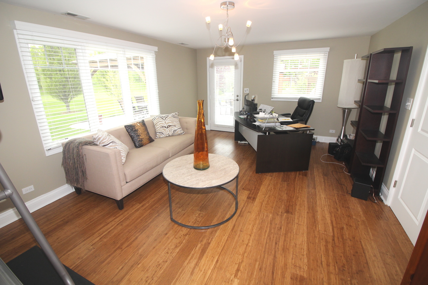 913 Surrey Road Addison, IL 60101 - Photo 31 of 44 a living room with furniture a large window wooden floor and a table