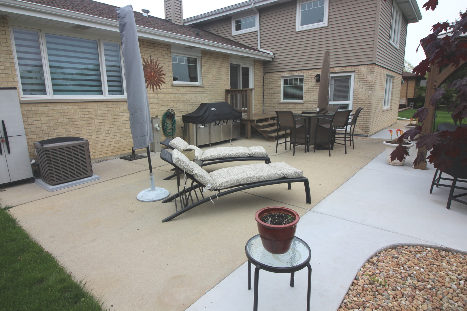 913 Surrey Road Addison, IL 60101 - Photo 39 of 44 a building outdoor space with patio furniture and potted plants