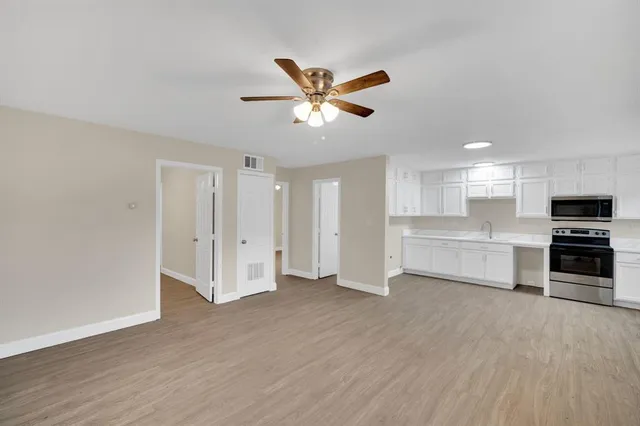 a view of a kitchen with a sink and a refrigerator