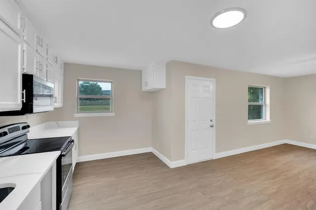 a kitchen with a stove and a microwave