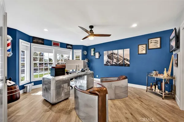 a living room with furniture kitchen view and a large window