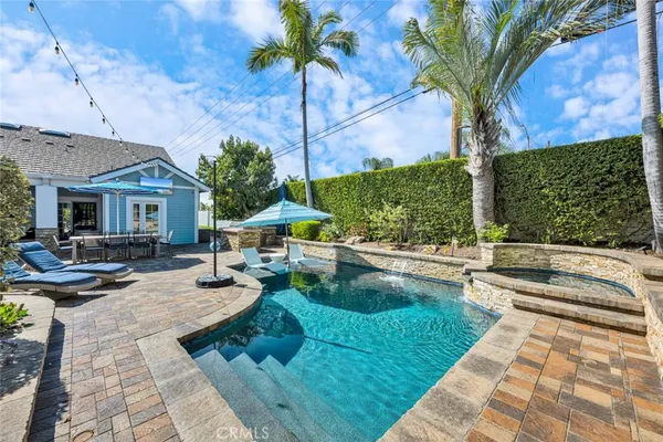 a view of a patio with swimming pool table and chairs