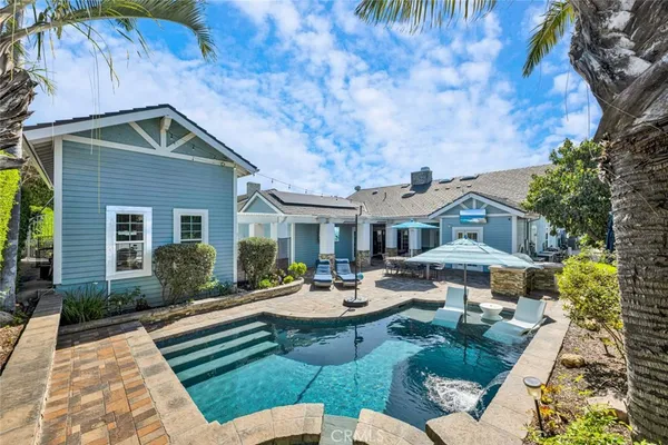 a view of a house with backyard sitting area and garden