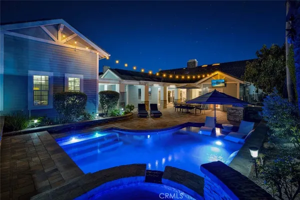 a view of a house with swimming pool and sitting area