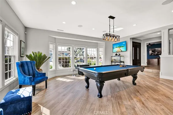 a living room with furniture a dining table and a floor to ceiling window
