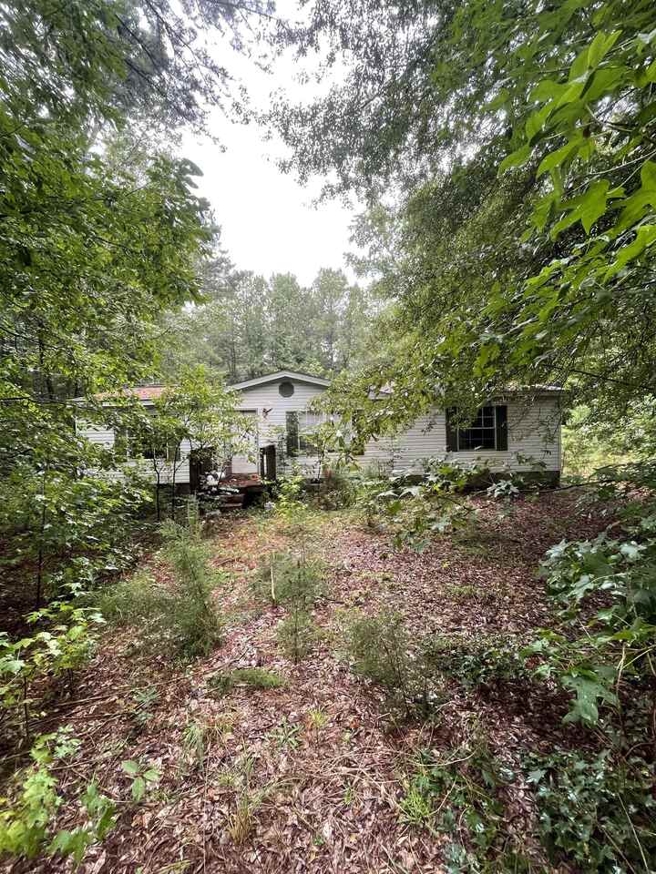 244 Steele Road Milner, GA 30257 - Photo 1 of 1 a backyard of a house with lots of green space