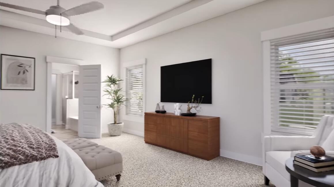 542 Staggerbush Street Freeport, FL 32439 - Photo 11 of 26 a bedroom with a bed and a flat screen tv