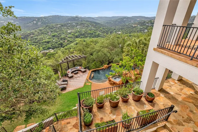 a view of a balcony with couches and wooden floor
