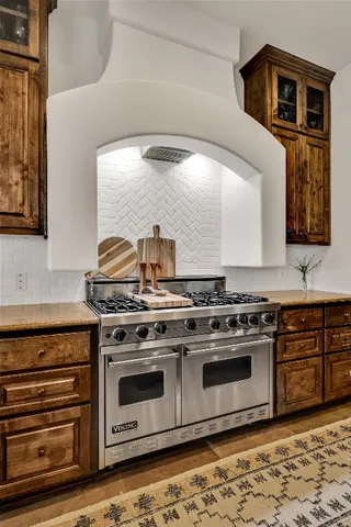 a stove top oven sitting inside of a kitchen