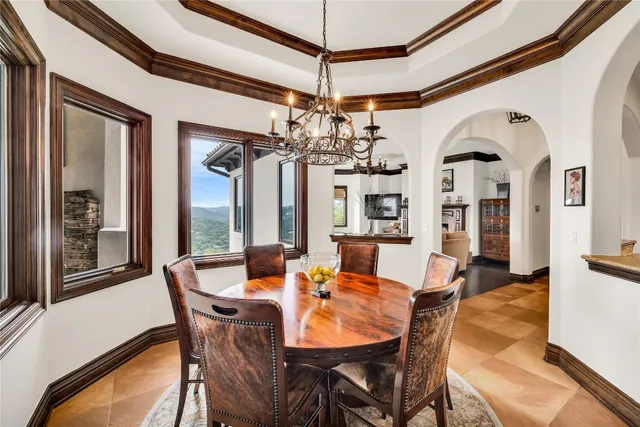 a view of a dining room with furniture and chandelier
