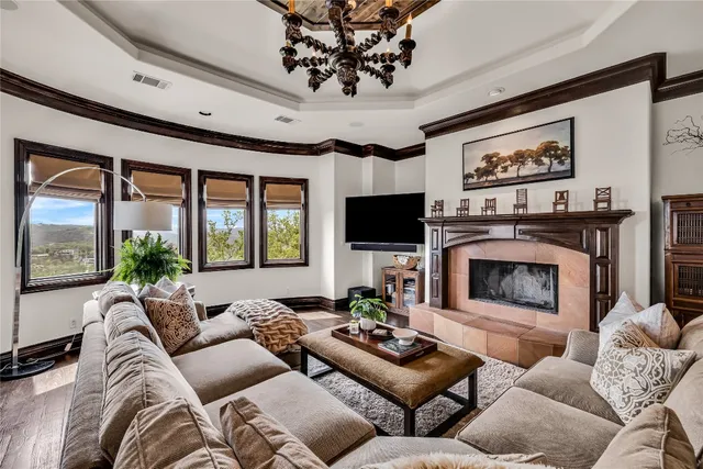 a living room with furniture a large window and a fireplace