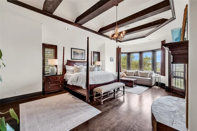 a bedroom with bed couch and window