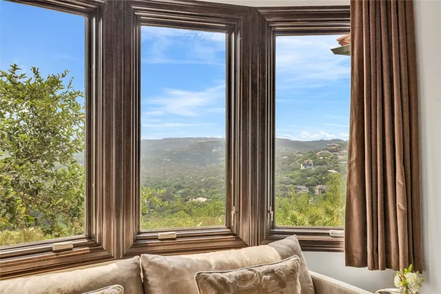 a view of a room that has a bed and a window