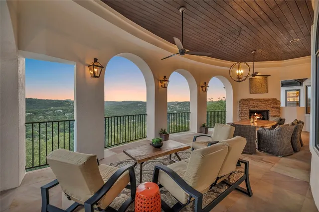 a living room with furniture a fireplace and a table