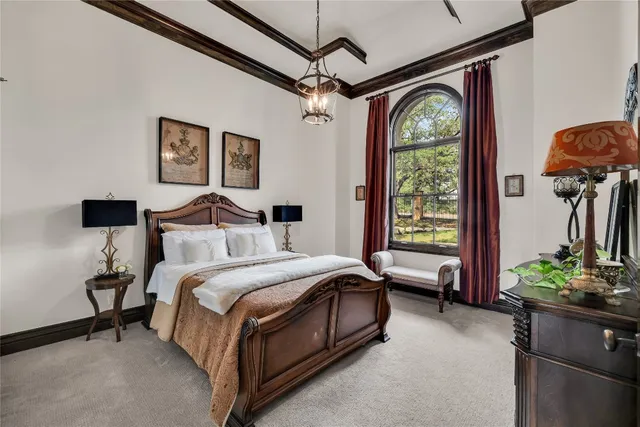 a bedroom with a bed and a chandelier