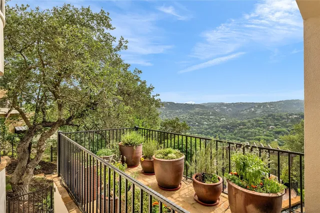 a view of a deck with two chair and a potted plant