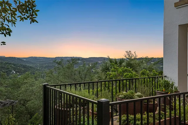 a view of a balcony with a forest