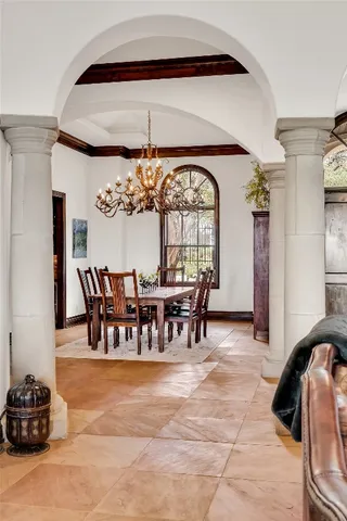 a view of a dining room with furniture and chandelier
