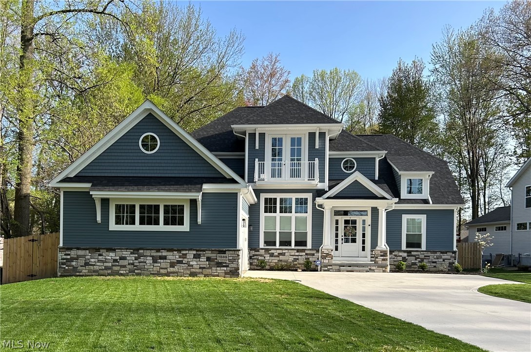 7598 Salida Road Mentor, OH 44060 - Photo 3 of 49 View of front of house with stone siding, a shingled roof, and a gate