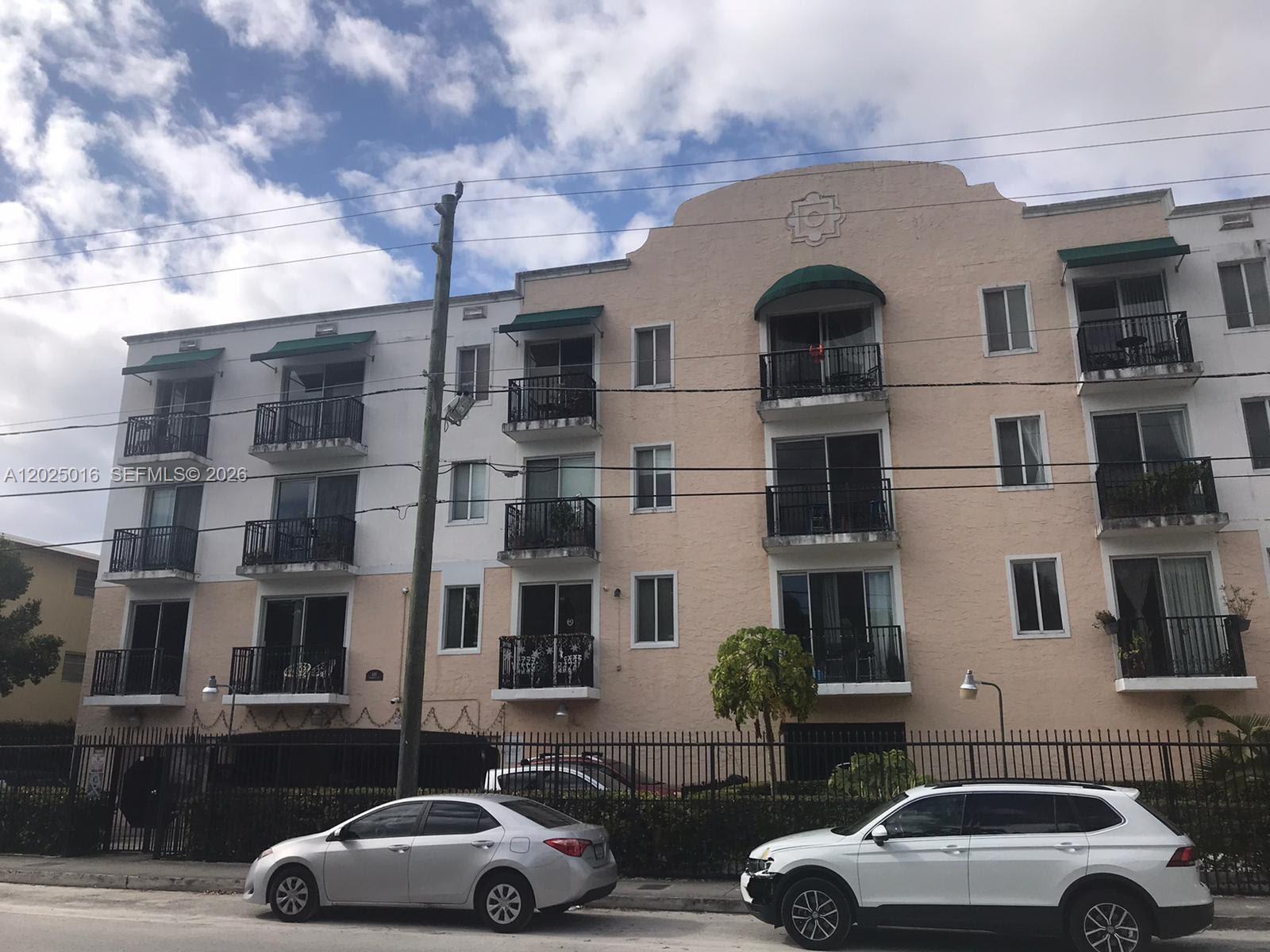 400 Southwest 2nd Street, Unit 201 Miami, FL 33130 - Photo 1 of 12 a couple of cars parked in front of a building