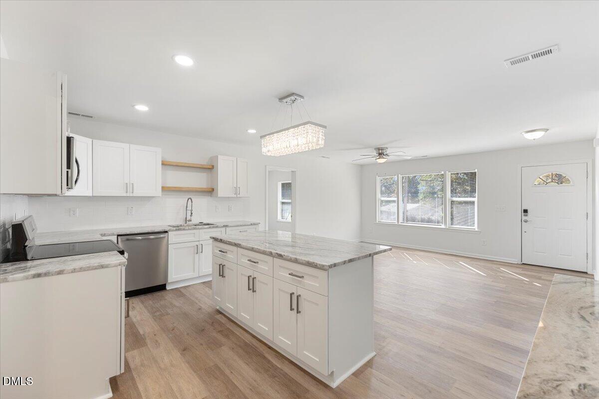 3305 Friar Tuck Road Raleigh, NC 27610 - Photo 1 of 18 a kitchen with granite countertop white cabinets and white appliances