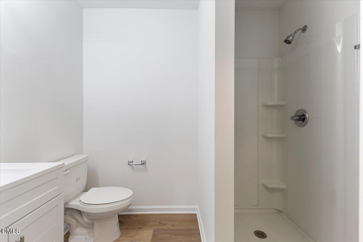 3305 Friar Tuck Road Raleigh, NC 27610 - Photo 12 of 18 a white toilet sitting next to a shower