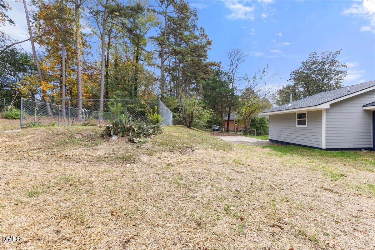 3305 Friar Tuck Road Raleigh, NC 27610 - Photo 16 of 18 a backyard of a house with lots of green space