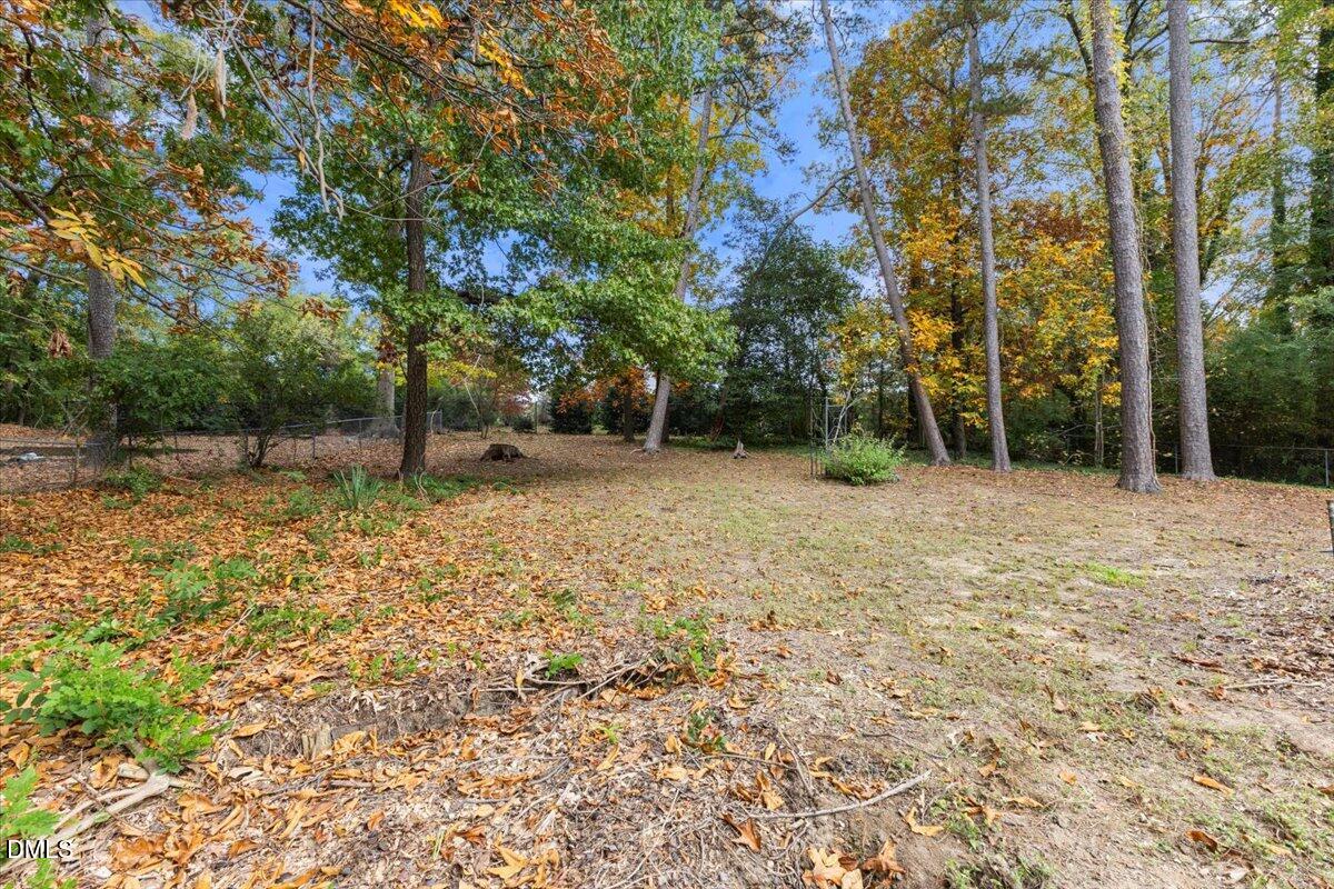 3305 Friar Tuck Road Raleigh, NC 27610 - Photo 17 of 18 a backyard of a house with lots of green space